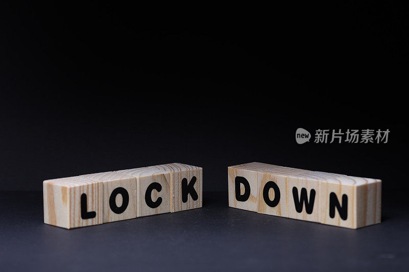 锁定& Down字木制方块上的黑色背景